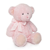 Soft pink teddy bear with a bow, sitting upright, features plush texture and gentle expression.